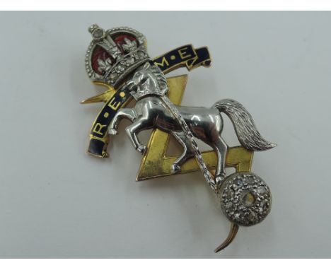A cased 9ct gold, platinum and enamel brooch regarding the Royal Electrical and Mechanical Engineers having diamond chip deco