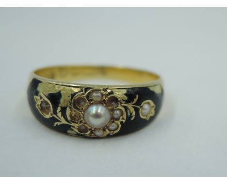 A Victorian 15ct gold mourning ring having seed pearl and black enamel decoration with hair panel to reverse, size R &amp; ap