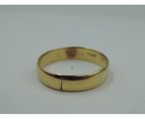 A yellow metal wedding band, marks worn, tests as 18ct gold, size R &amp; approx 3g