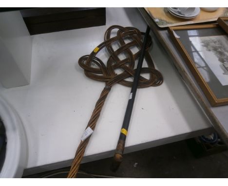 copper topped walking cane and a carpet beater