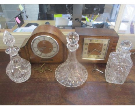 Two mid 20th century oak cased mantel clocks to include a Smiths 8-day clock, together with three glass decanters 