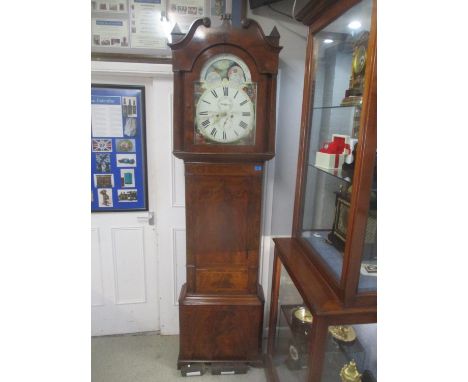 A late 18th/early 19th century mahogany cased 8-day long case clock having a painted arched top dial with moon phase and name