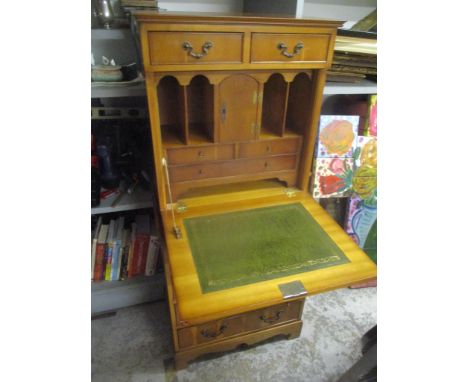 A late 20th century yew bureau with a fall front over drawers, on bracket feet, 133h x 59cm w 