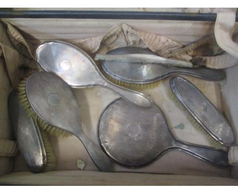 Silver backed dressing table items to include three hair brushes, two clothes brushes, a mirror and a comb 