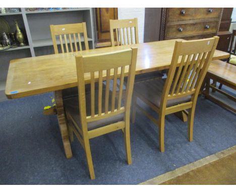 A light oak trestle end table with a set of four light oak dining chairs with slat backs and brown leather seats 75cm h x 74c