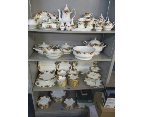 A Royal Albert Country Roses extensive dinner, tea and coffee service including a soup tureen and ladle, vegetable tureens, c
