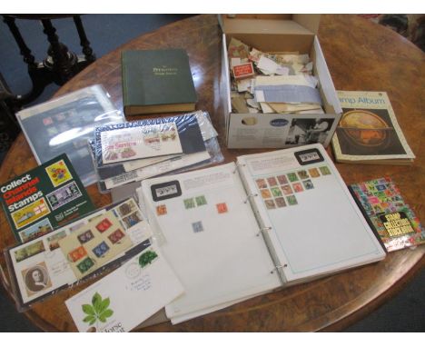 A group of stamp albums, First Day covers, loose stamps and stock pages containing stamps from around the world including GB 