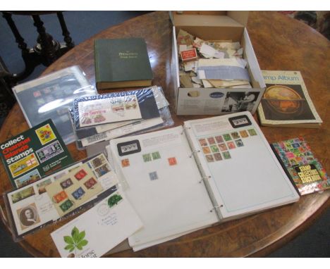 A group of stamp albums, First Day covers, loose stamps and stock pages containing stamps from around the world including GB 