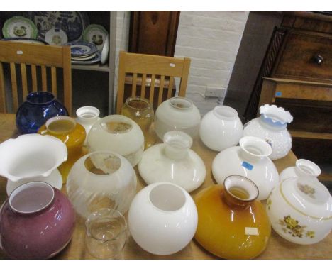 A large quantity of vintage oil lamp and glass shades Location: RAB 