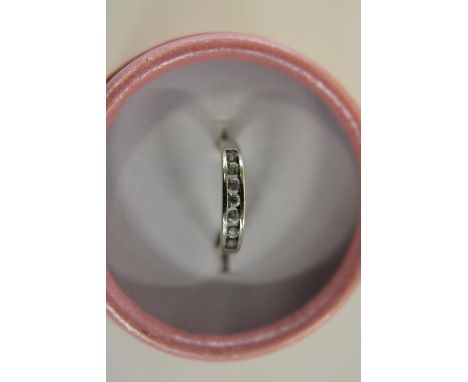 A 9ct white gold channel set half eternity ring size M 1/2 