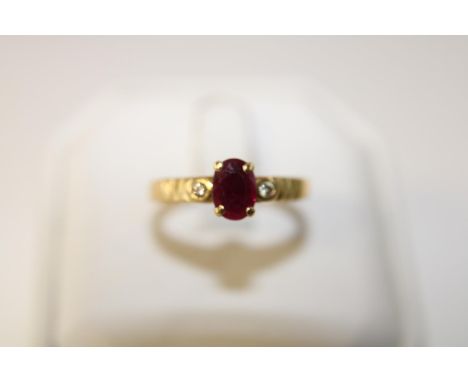 A 18ct gold ruby solitaire ring set with diamonds. size Q 