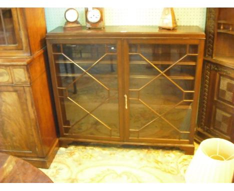 An Edwardian mahogany display cabinet, the rectangular top over a pair of astragal glazed doors enclosing three adjustable sh