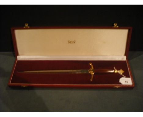 Wilkinson Sword, a presentation piece fashioned as a Norman/Saxon sword with wood handle, gilt metal cross-guard and engraved