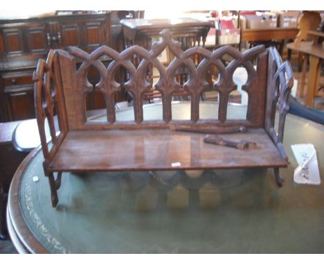 A carved oak folding book shelf of puginesque form.