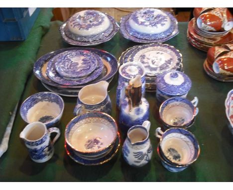 A mixed lot of largely Edwardian blue and white transfer decorated pottery, including a pair of covered tureens, cups, saucer