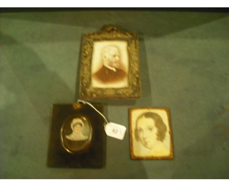 A 19th century portrait miniature of a lady wearing lace bonnet and black gown, 8 x 6cm oval in ebonised frame, together with
