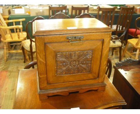 An Edwardian oak stationery cabinet, the rectangular top with moulded edge over a panelled fall, enclosing scriber and fitted