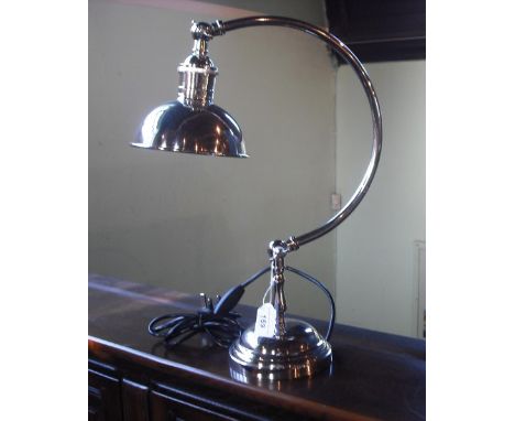 A nickel plated desk lamp on turned support with adjustable column.