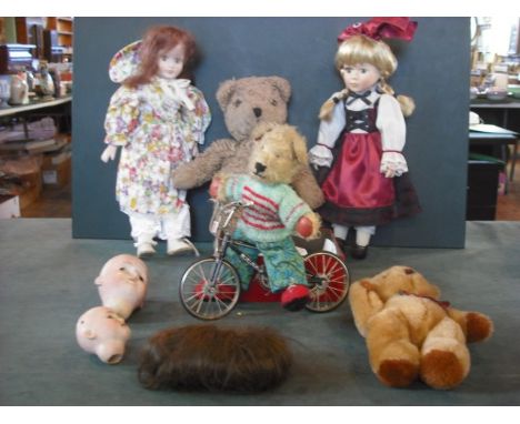 A mixed lot, including two early 20th century bisque dolls heads, a scale model bicycle, three teddy bears and two contempora