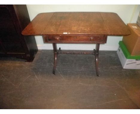 A Regency oak sofa table, the square top and twin drop flaps over single drawer on square tapering and splayed supports with 