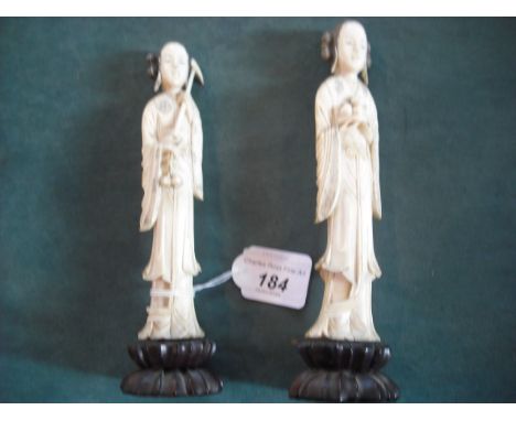 A pair of late 19th/early 20th century carved ivory Chinese figures, each of a young lady, one holding a plate of peaches, th