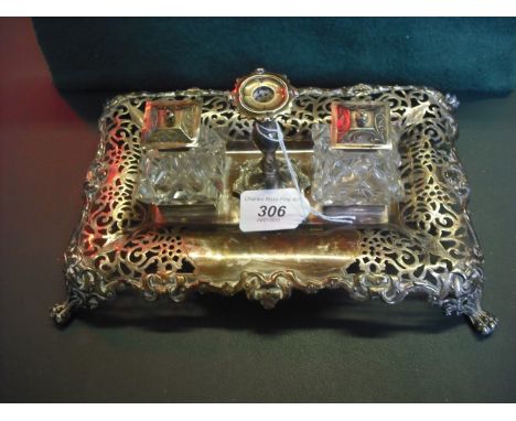 Henry Wilkinson & Co., a silver inkstand of rectangular pierced form, supporting a pair of cut glass silver mounted wells and