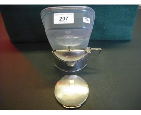 A silver lidded mustard of navette form, having flame finial, the pierced body enclosing blue glass liner, together with a si