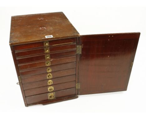 A kit of 70 carving tools, screw vice and other tools contained in a 9 drawer mahogany chest with brass pulls behind hinged d