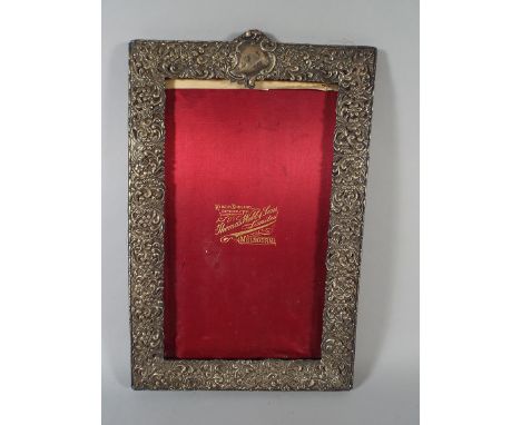 A Silver Easel Photo Frame with Floriate Decoration in Relief. 36x23cm