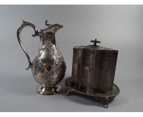 A Victorian Silver Plate Hot Water Jug together with Shaped Biscuit Caddy on Four Scrolled Feet.