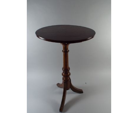 A 19th Century Oak Candle Stand with a Circular Top Supported on a Turned Stem and Tripod Legs. 65cm High