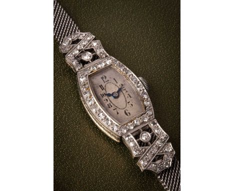 A lady's Art Deco diamond set cocktail wristwatch, the silvered dial with Arabic numerals and diamond bezel, fitted a 9ct gol