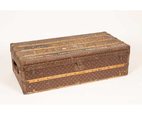 A 1920s leather wrappd Louis Vuitton trunk with wooden and nailhead studded straps and leather carrying handles, hand painted