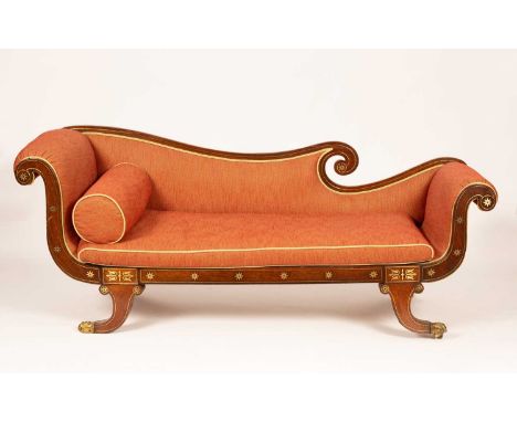 A Regency mahogany and brass inlaid sofa or chaise, the serpentine scroll back with overscroll arms, the loose cushion seat w