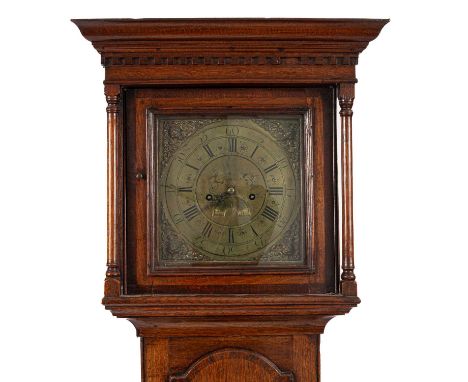 An eight-day oak longcase clock, the square 27cm brass dial with roman numerals and putti corner details, four pillar movemen