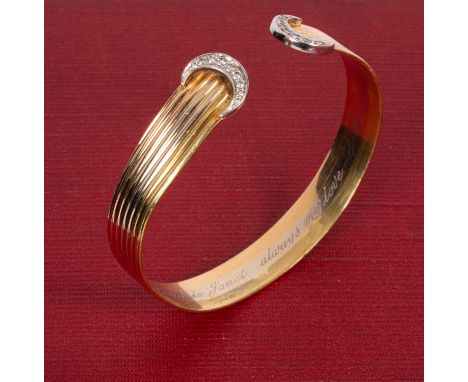 A tri-colour 18ct gold bangle, in the manner of Cartier, the reeded bangle with diamond set crescents to the terminals, inscr