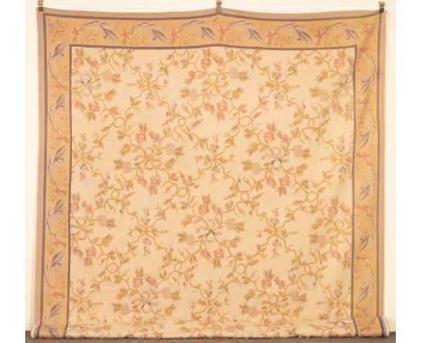 An Aubusson style tapestry, the ivory field with all over flowering vines framed by a sand border of scrolling leaves and flo