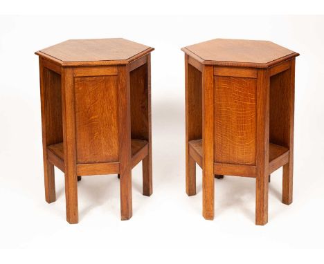 A pair of Arts &amp; Crafts oak hexagonal bedside tables, of two tiers, the top 44.5cm diameter, 68.5cm highOverall good cond