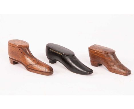 Wooden shoe snuff boxes, 10.5cm long and 9.5cm long and a black lacquered shoe snuff box, 12cm longQty: 3