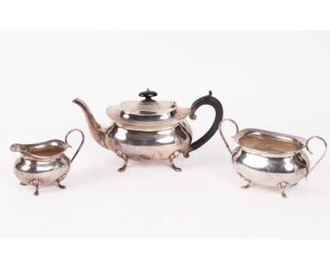 A three-piece silver tea set, J G Ltd., Birmingham 1922, of bellied oval form, the teapot with ebonised finial and handle, ap