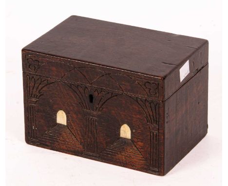 A 17th Century style oak tea caddy with a double arch carved front and bone inlaid faux doors, the hinged top opening to reve