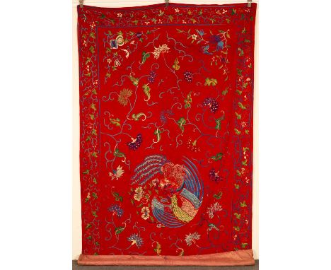 A 19th Century Chinese wall hanging, the red ground with silk embroidered phoenix, butterfly and floral decoration and a scro