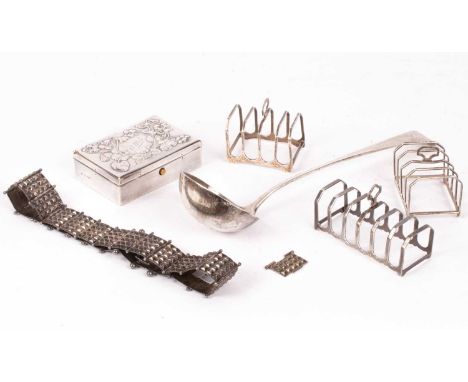 A quantity of silver including a pair of silver toast racks, Birmingham 1929, another silver toast rack, a silver ladle, a si