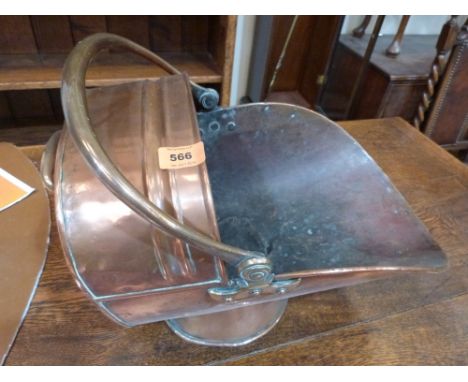A copper helmet coal scuttle