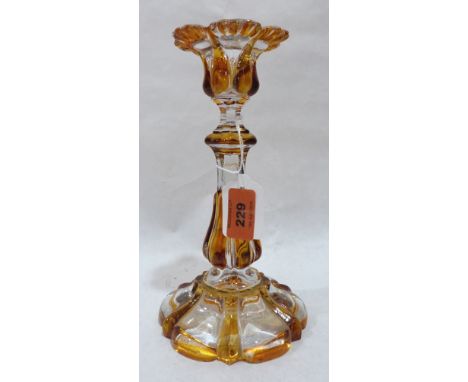 A 19th century amber flashed glass candlestick. 9' high