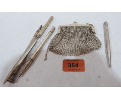 A silver chain mail evening purse, two silver propelling pencils, a white metal example and a paper knife