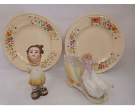A pair of Clarice Cliff plates, a bisque group and an Austrian figure of a child