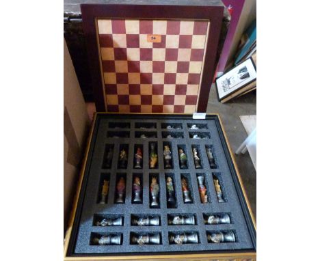 A boxed chess set with resinous pieces