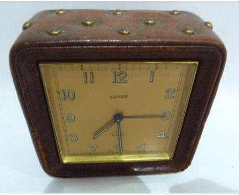 A Favre Leuba Luxor alarm clock, with frosted gilt dial and brass studded leather case. c. 1950. 4' high