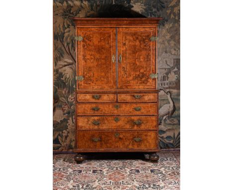 A WILLIAM & MARY BURR WALNUT AND MARQUETRY CABINET ON CHESTCIRCA 1690The doors enclosing an arrangement of short and long dra